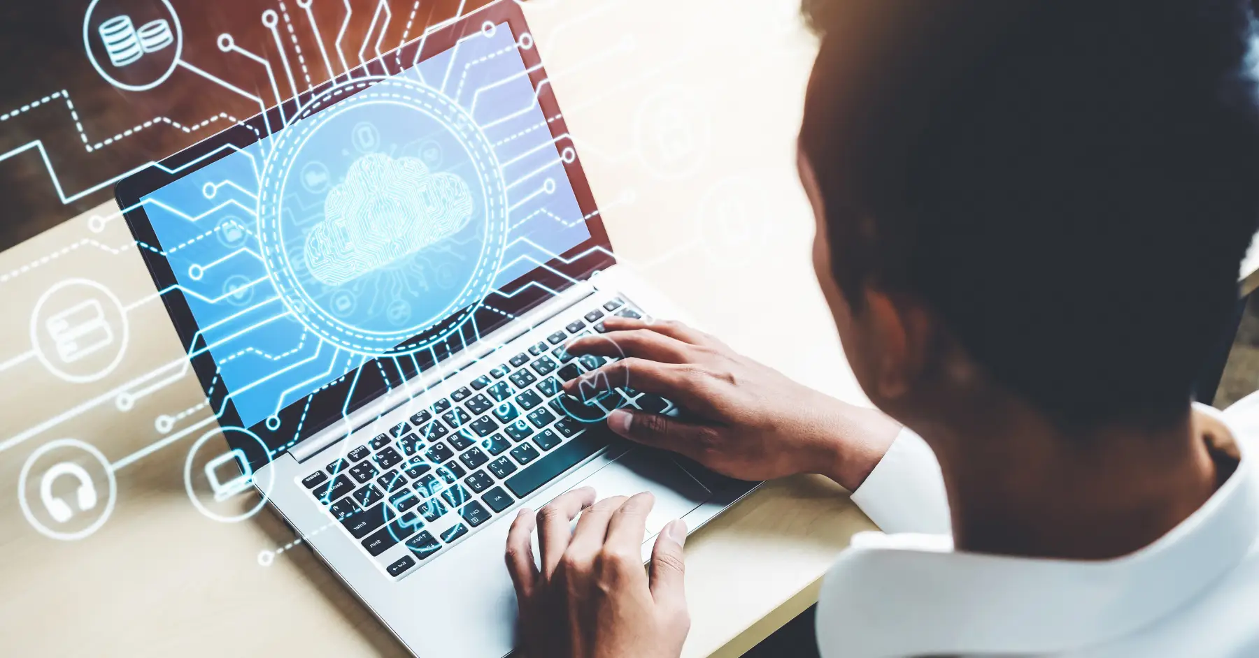 Man researching cloud computing certifications on a laptop displaying digital graphics and AI concepts.