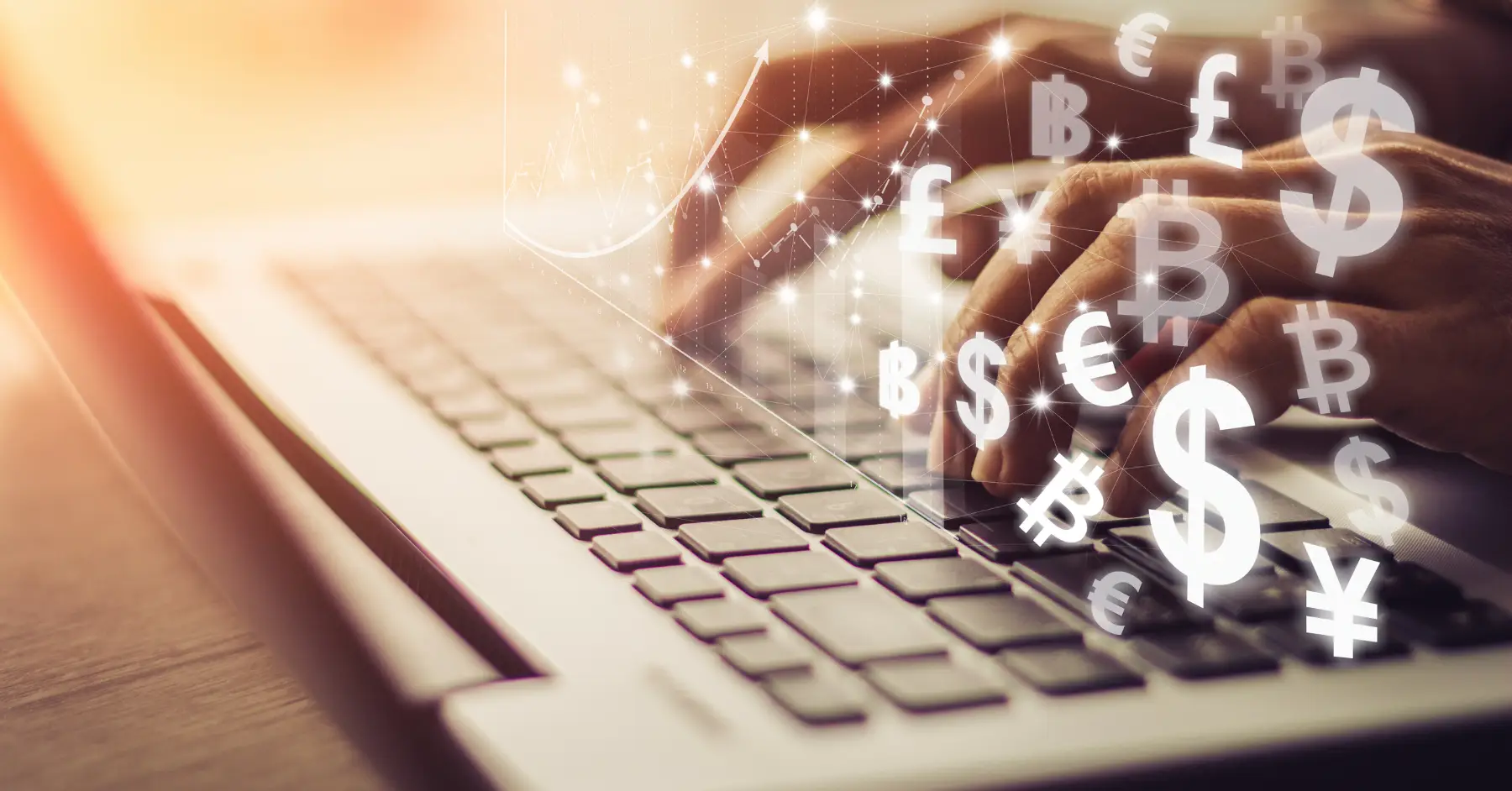 Hands typing on a laptop with symbols of various currencies and financial graphs floating above.