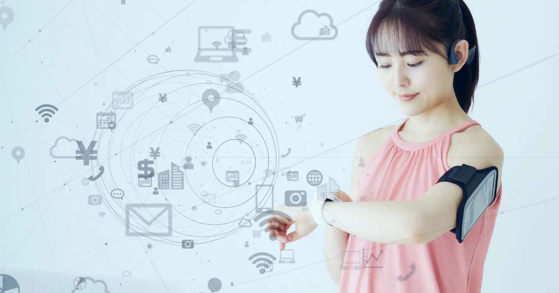 Woman checking her smartwatch, integrated with various digital connectivity icons, symbolizing wearable technology trends.