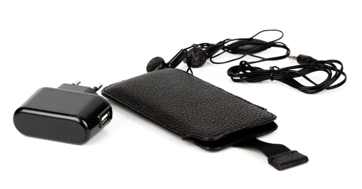 A collection of phone accessories including a charger, cable, earphones, and a black carrying case on a white background.
