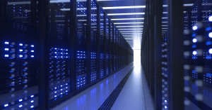Long corridor of server racks in a data center illuminated by blue lights, symbolizing modern network infrastructure.