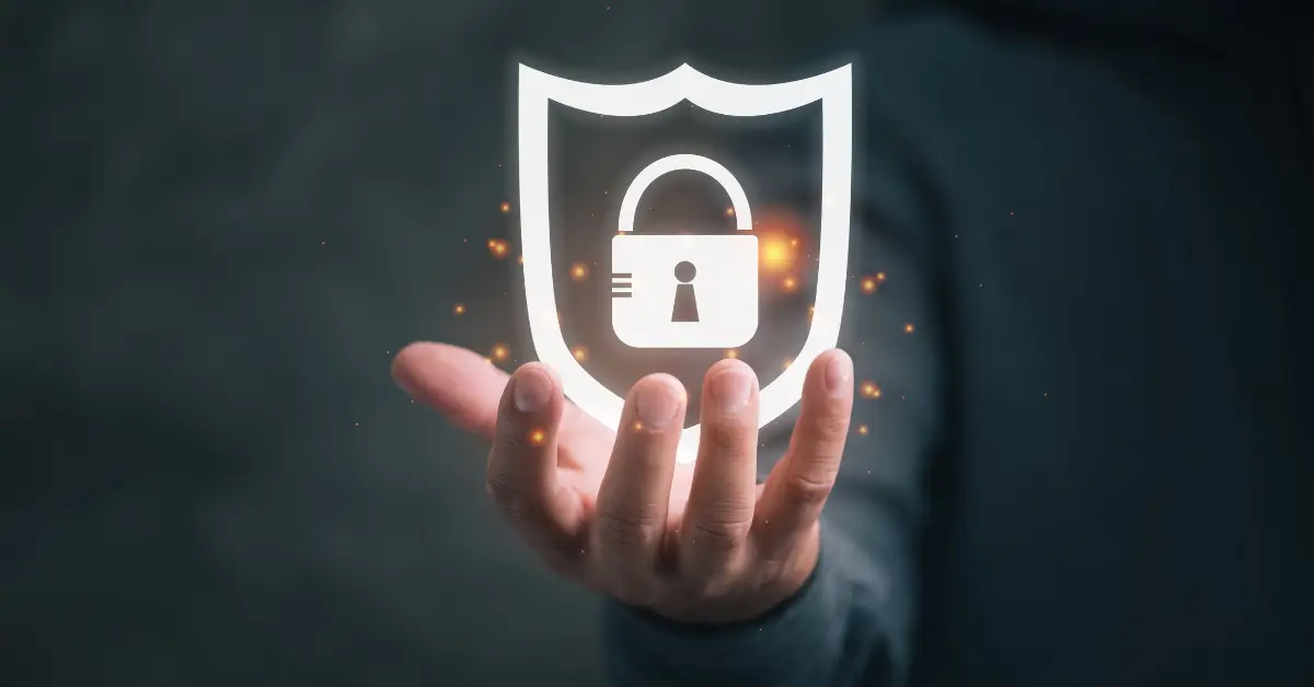 Hand projecting a digital security shield with a padlock, symbolizing cybersecurity protection.