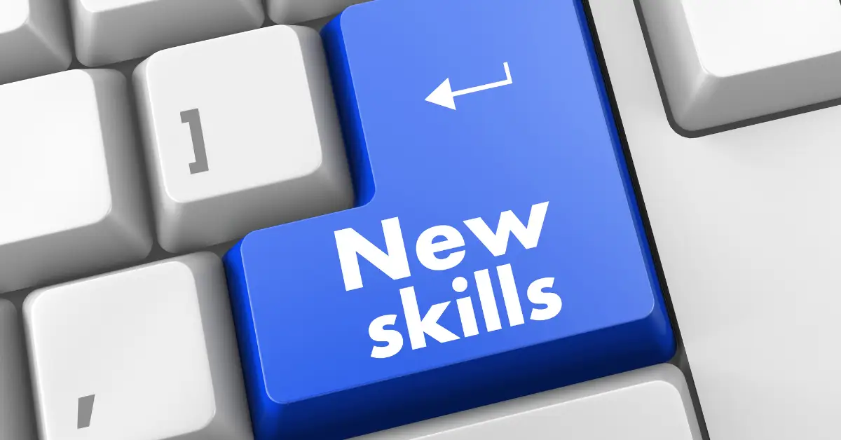 Computer keyboard with a prominent blue 'New Skills' key symbolizing skill enhancement and learning.