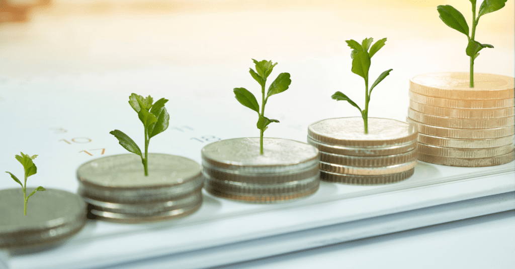 Young plants growing from coins symbolizing investment and growth over time.