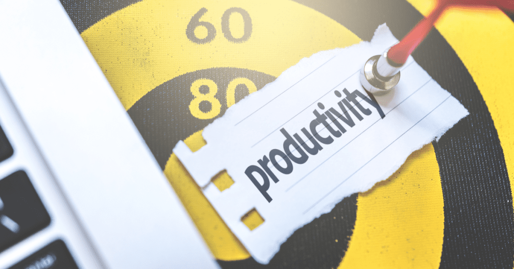 Conceptual image of productivity with a torn paper labeled 'productivity' pinned to a speedometer, emphasizing efficiency and performance.