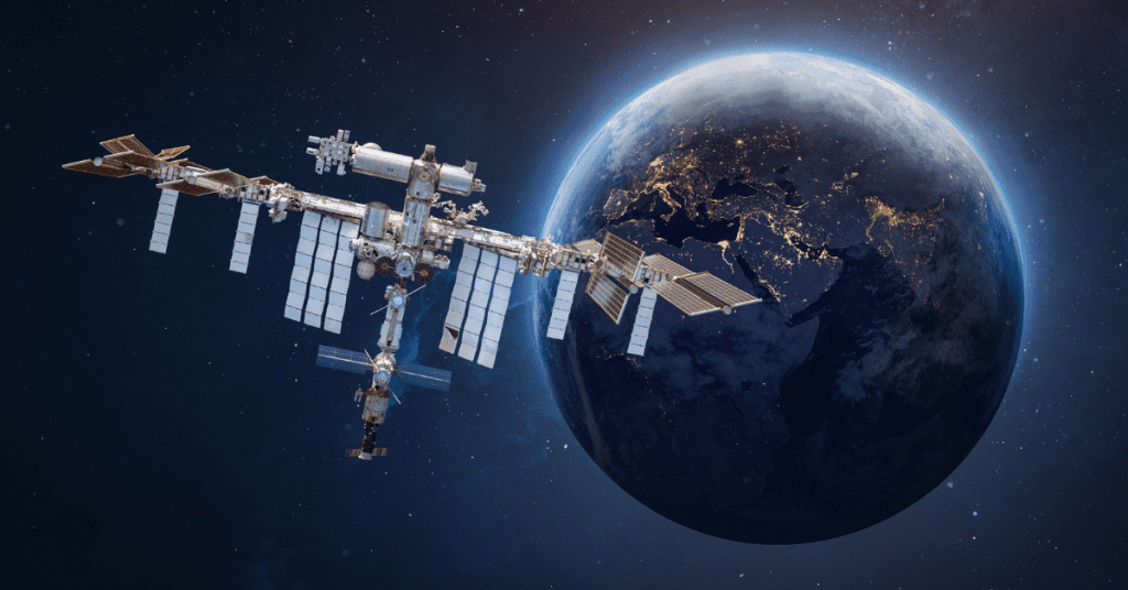 Illustration of the International Space Station orbiting Earth, showcasing its complex structure and the planet's illuminated night side.