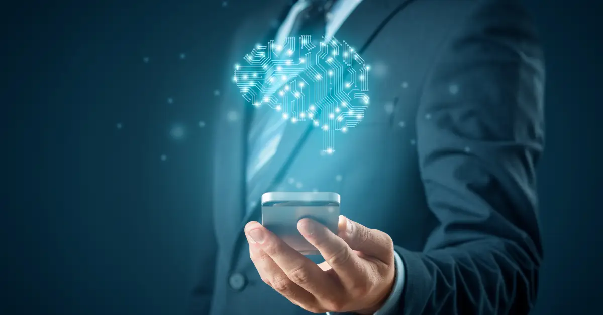 Businessman using a smartphone with a holographic brain symbol, representing AI technology in business.