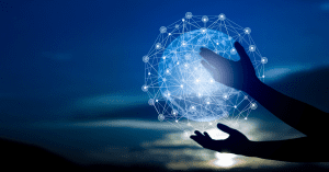 Silhouetted hands interacting with a glowing digital network globe against a twilight sky.