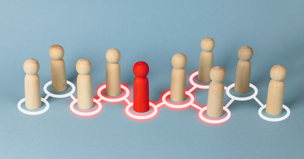 Conceptual image of a red figure connected to a network of other figures, symbolizing leadership and influence in a group.