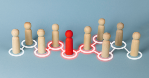 Conceptual image of a red figure connected to a network of other figures, symbolizing leadership and influence in a group.